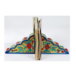 Ceramic Decorative bookends with a book placed between them Bookends are used to keep books upright on a shelf or desk they come in various materials, including metal, wood, stone, and fabric. Bookends can be functional and decorative, adding to the aesthetic of a space the term "bookend" #9081