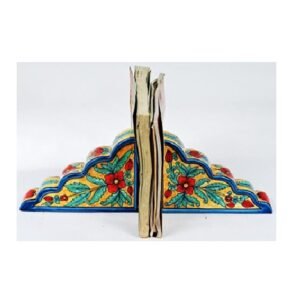 Ceramic Decorative bookends with a book placed between them Bookends are used to keep books upright on a shelf or desk they come in various materials, including metal, wood, stone, and fabric. Bookends can be functional and decorative, adding to the aesthetic of a space the term "bookend" #9081