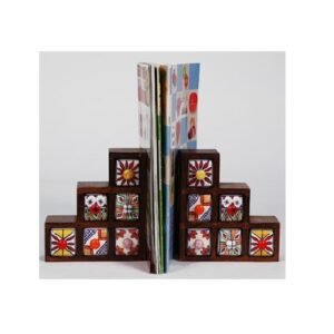 Ceramic Decorative bookends with a book placed between them Bookends are used to keep books upright on a shelf or desk they come in various materials, including metal, wood, stone, and fabric. Bookends can be functional and decorative, adding to the aesthetic of a space the term "bookend" #9082