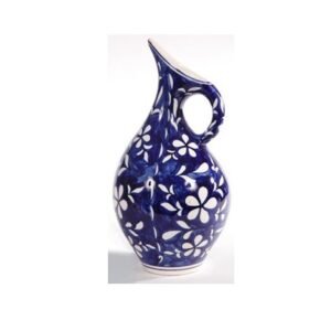 Ceramic jug, likely used for holding and pouring liquids It features a distinct blue and white floral pattern and a unique handle design Jugs like this are often used for serving water, juice, or other beverages #9108